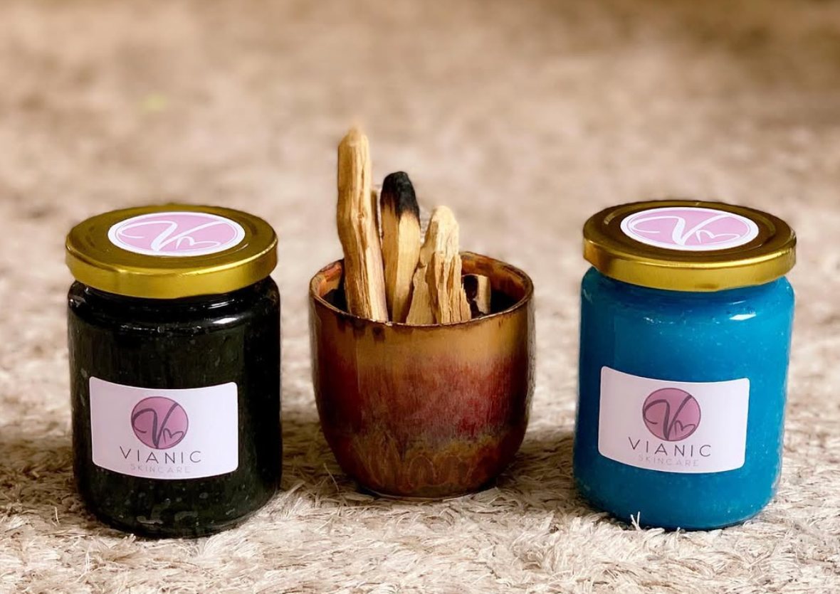 Two Vianic scrub jars beside palo santo sticks